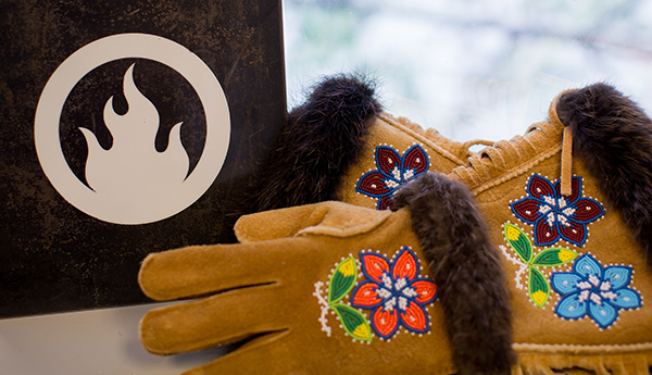 Indigenous mittens with beaded embroidery, alongside the Creative Fire logo.